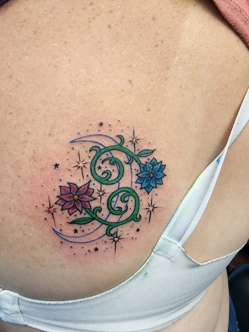 Flowers with stars as a back tattoo