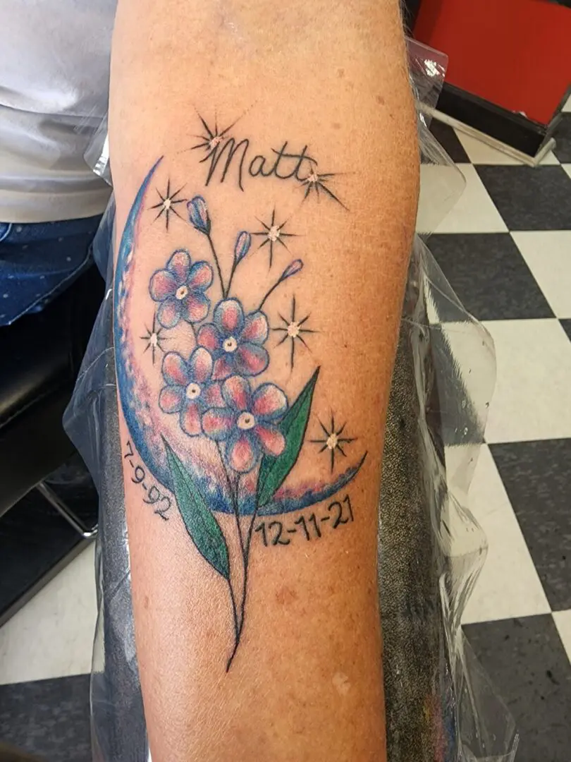 A crescent moon with flowers tattoo dedicated to Matt