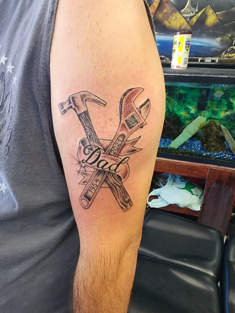 An arm tattoo dedicated to dad